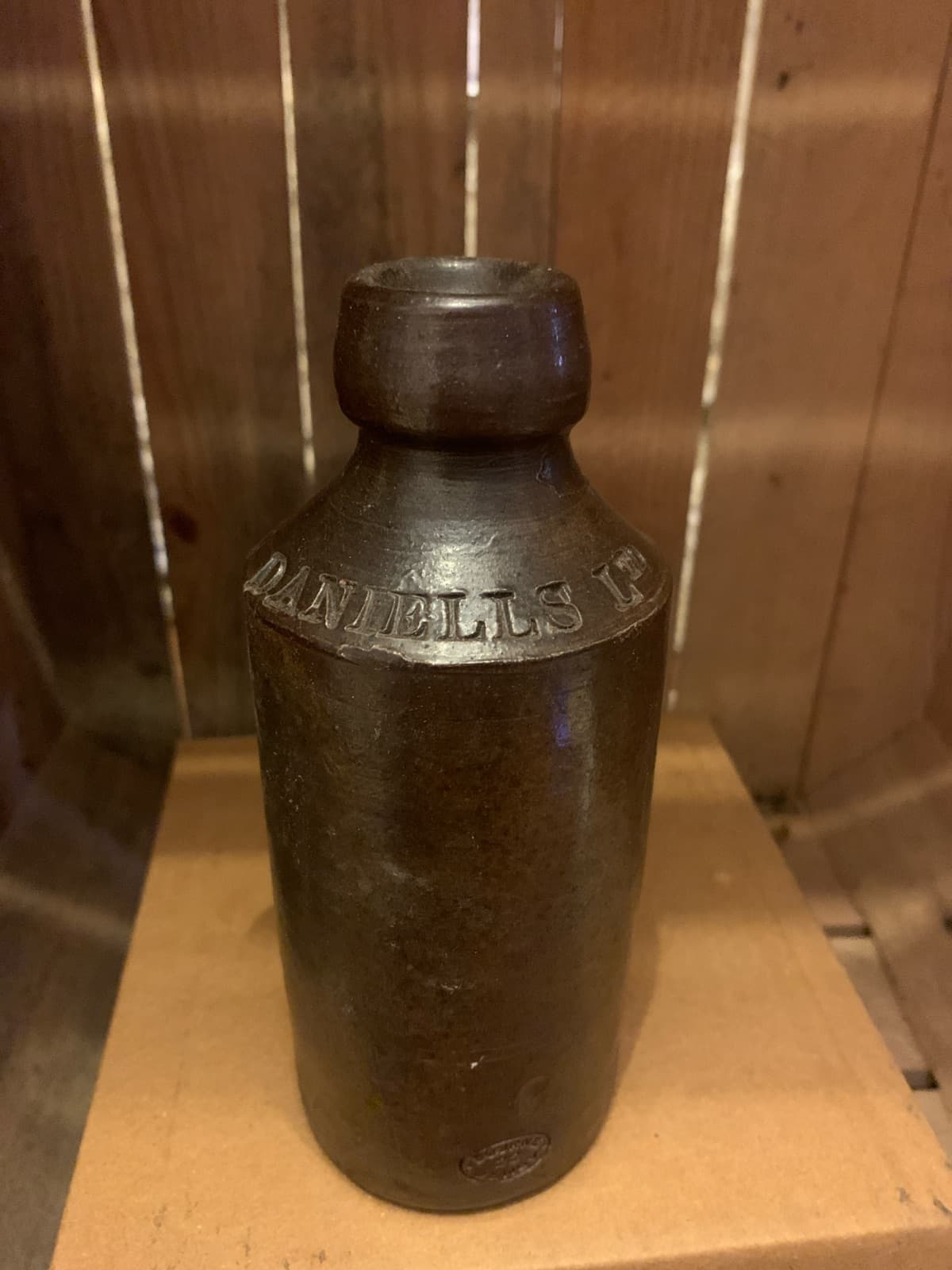 Vintage Stoneware Bottle with Embossed Text