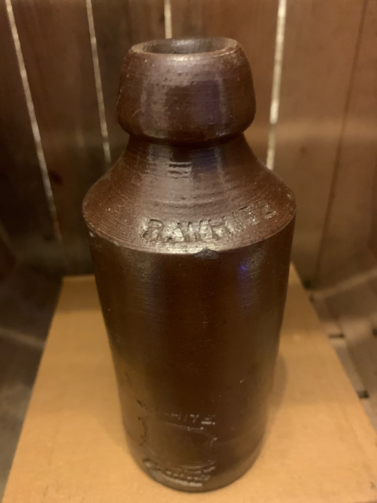 Vintage Stoneware Bottle with Embossed Text