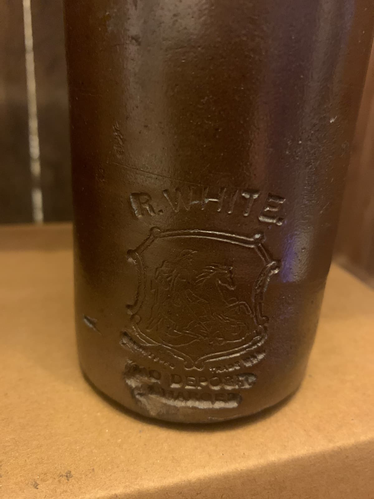 Vintage Stoneware Bottle with Embossed Text