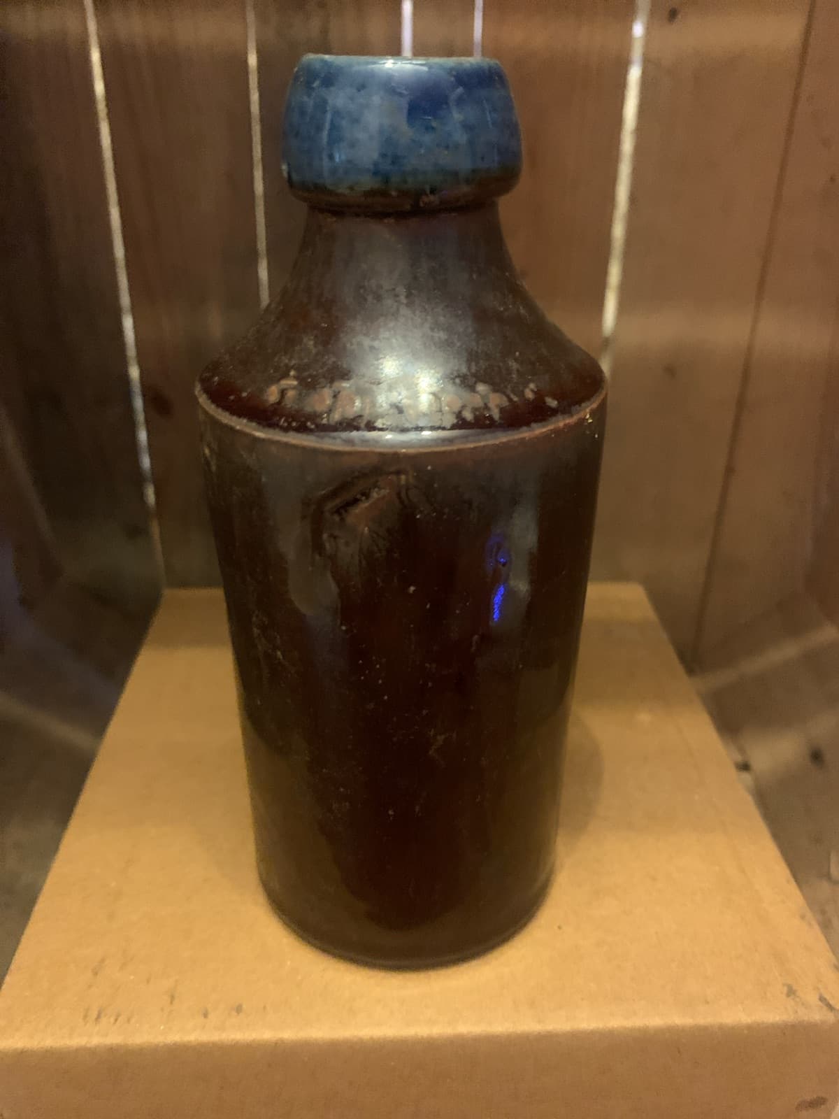 Vintage Dark Stoneware Bottle with Blue Ceramic top