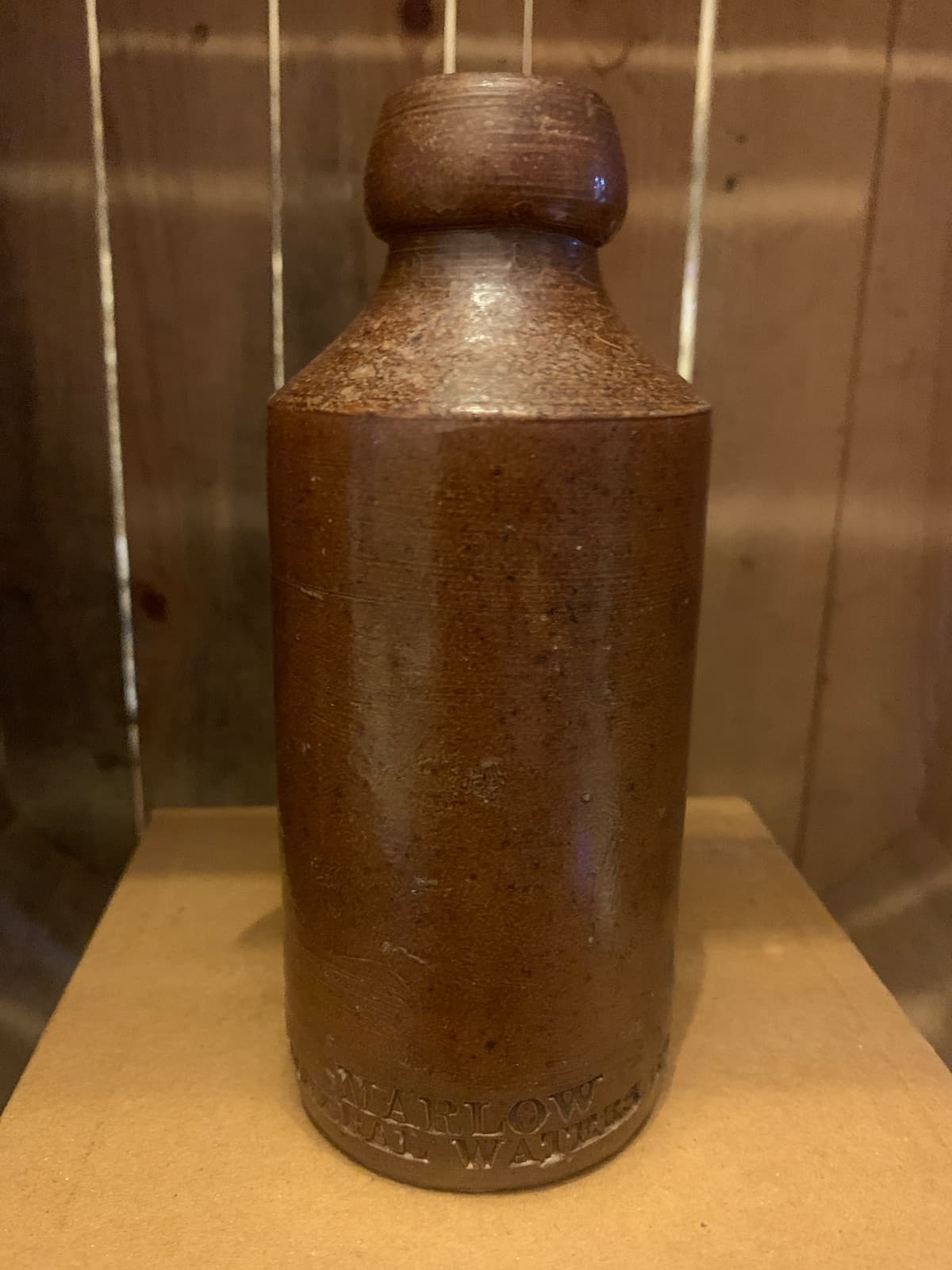 Vintage Brown Stoneware Bottle with Embossed Text