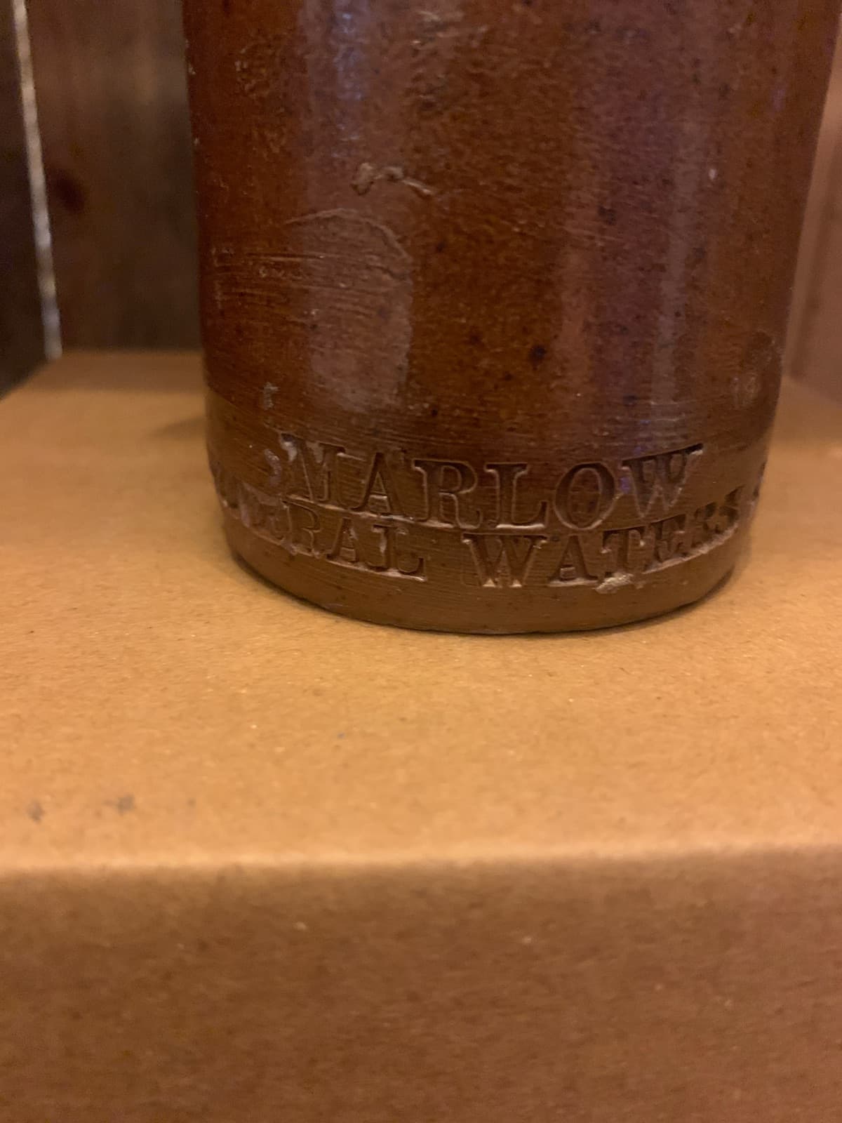 Vintage Brown Stoneware Bottle with Embossed Text